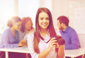 Image showing smiling female photographer with photocamera