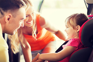 Image showing parents talking to little girl in baby car seat