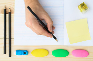 Image showing Human hands with pencil and erase rubber