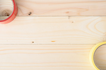 Image showing top view eof tape on wooden board