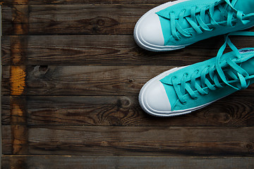 Image showing blue shoes on empty wooden parquet