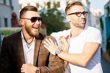 Image showing Two cheerful stylish guy met on sunny summer day