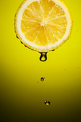 Image showing Drop of lemon juice falling down.