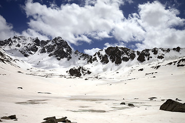 Image showing Frozen mountain lake covered with snow at sun day