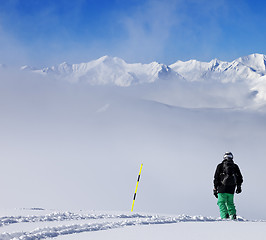 Image showing Snowboarder on snowy slope with new fallen snow