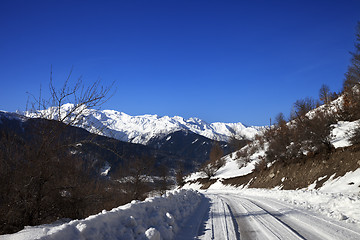 Image showing Ice-covered road in winter snow mountain at sun cold morning