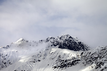 Image showing Snow sunlight mountain in fog at gray day