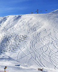 Image showing Off-piste slope with trace from ski and snowboard at sun morning