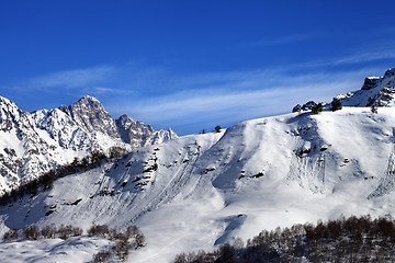 Image showing Off-piste slope with track from avalanche on sun day