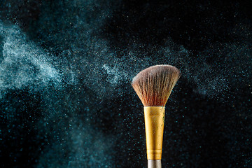 Image showing Brush with crumble shadows on black empty background