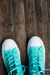 Image showing sneakers on empty wooden surface