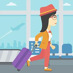 Image showing Woman walking with suitcase at the airport.