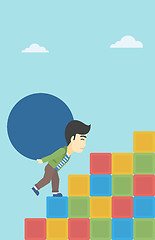 Image showing Man carrying concrete ball uphill.