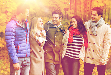 Image showing group of smiling men and women in autumn park