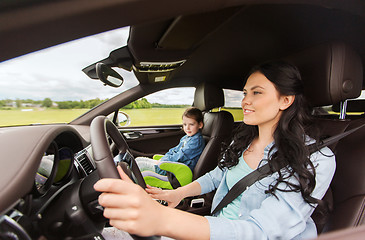 Image showing happy woman with little child driving in car