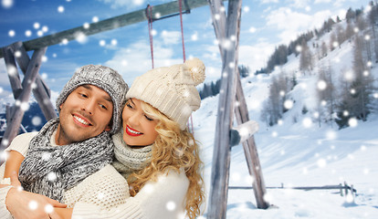 Image showing happy family couple in winter clothes hugging