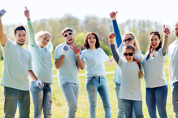 Image showing group of volunteers showing thumbs up in park