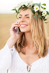 Image showing happy young woman calling on smartphone at country