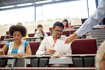 Image showing teacher giving tests to students at lecture