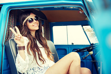 Image showing happy hippie woman showing peace in minivan car