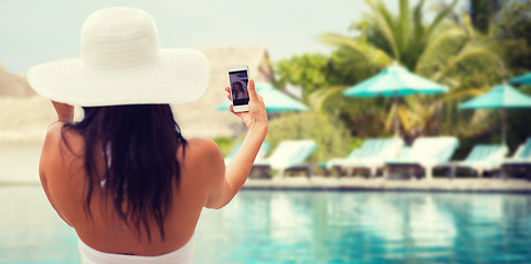 Image showing smiling young woman taking selfie with smartphone