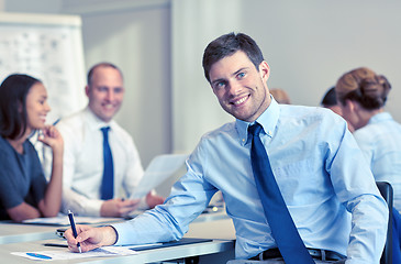 Image showing group of smiling businesspeople meeting in office