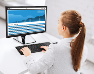 Image showing businesswoman with graphs on computer at office