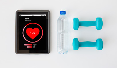 Image showing close up of tablet pc, dumbbells and water bottle