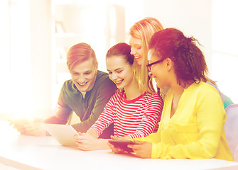 Image showing smiling students looking at tablet pc at school