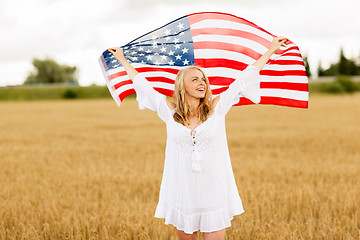 Image showing happy woman with american flag on cereal field