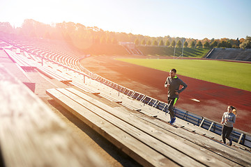 Image showing happy couple running upstairs on stadium