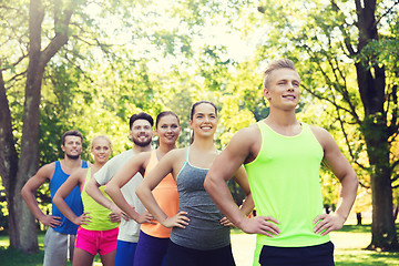 Image showing group of happy friends or sportsmen outdoors