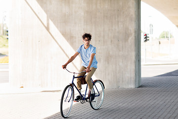 Image showing young hipster man riding fixed gear bike