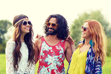 Image showing smiling young hippie friends talking outdoors