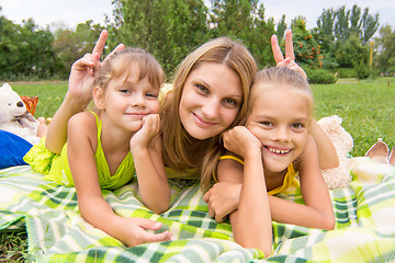 Image showing Mom horns and offered two daughters and a fun look into the frame