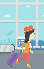 Image showing Woman walking with suitcase at the airport.