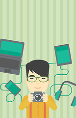 Image showing Young man surrounded with his gadgets.