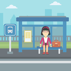 Image showing Woman waiting for bus at the bus stop.