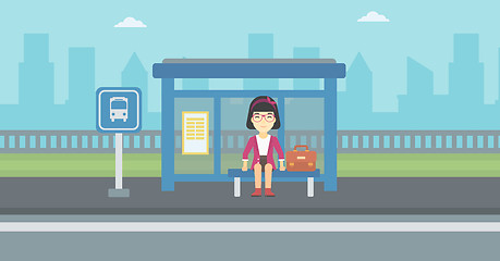 Image showing Woman waiting for bus at the bus stop.