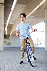 Image showing young hipster man riding fixed gear bike