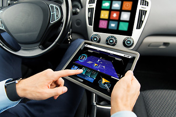 Image showing close up of man with tablet pc in car