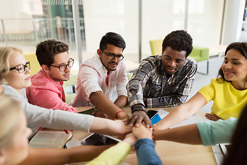 Image showing group of international students with hands on top