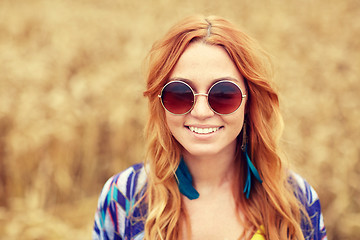 Image showing smiling young redhead hippie woman outdoors