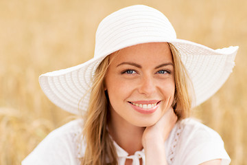 Image showing close up of happy woman in sun hat on cereal field