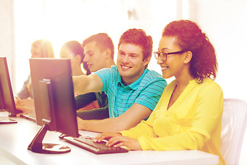 Image showing smiling students in computer class at school