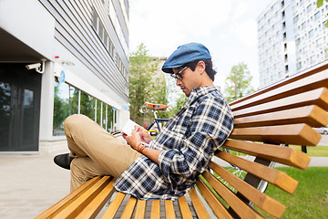 Image showing man with notebook or diary writing on city street