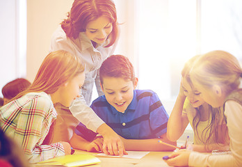 Image showing group of school kids writing test in classroom