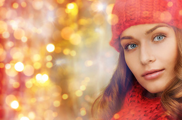 Image showing happy woman in hat and scarf over lights