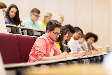 Image showing group of students with notebooks in lecture hall