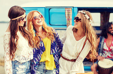 Image showing happy hippie friends having fun over minivan car